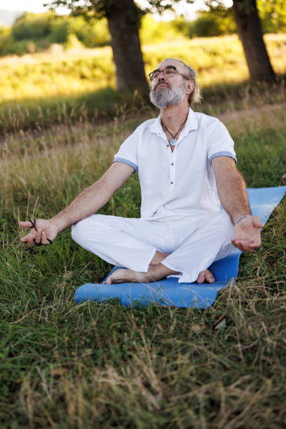 istock Mature man meditating in nature 1416821328