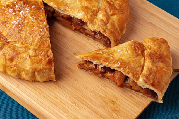 istock Apple pie on a wooden board close up 1416822318