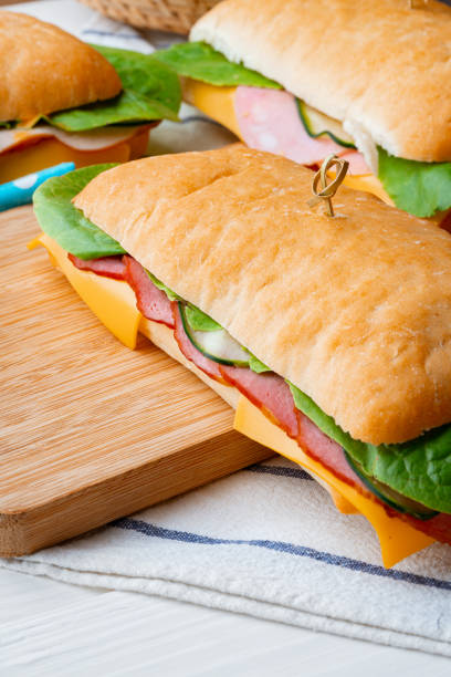 istock Sandwich with ham and cheese on wooden board 1416822642