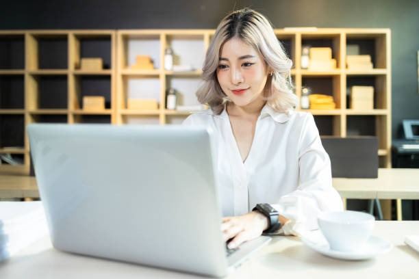 istock Beautiful Asian woman successful startup small and medium enterprise using computer laptop work at the home office, SME entrepreneur business, Startup Asian woman use laptop checking information. 1416822992