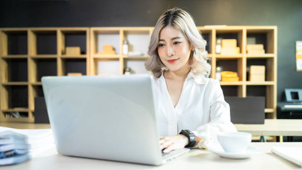 istock Beautiful Asian woman successful startup small and medium enterprise using computer laptop work at the home office, SME entrepreneur business, Startup Asian woman use laptop checking information. 1416823022