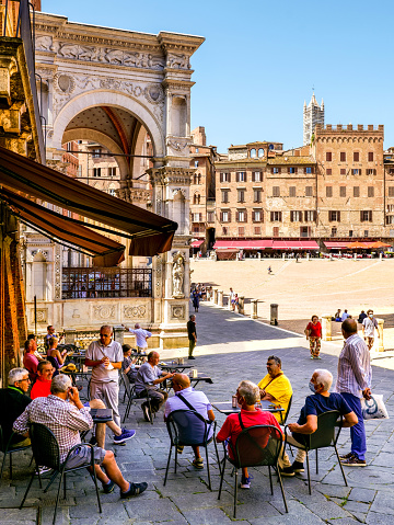 Glimpse of Piazza del Duomo in Florence visited by numerous tourists, where overlooks the cathedral complex: the Cattedrale di Santa Maria del Fiore, the Battistero di San Giovanni and the Giotto's Campanile, all part of the UNESCO World Heritage Site.