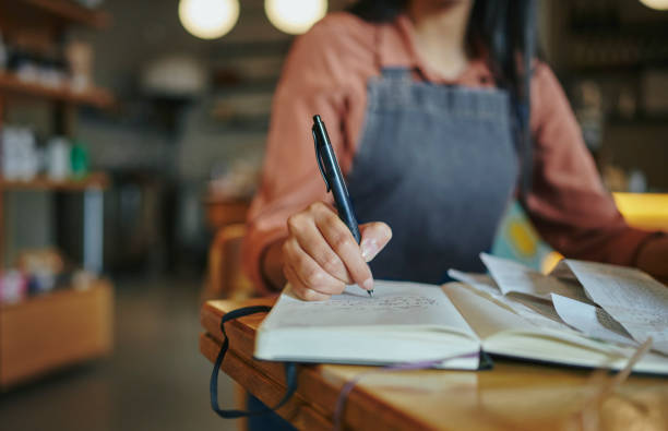 istock Female deli manager working at a table in her artisanal store 1416830886