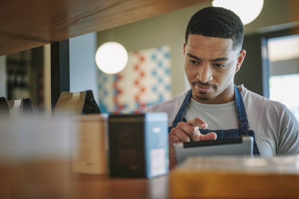 istock Deli owner using a digital tablet to check stock on shelves 1416831640
