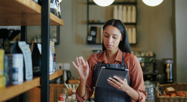 istock Young deli owner doing inventory on a tablet in her shop 1416832337