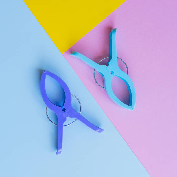 istock Flat lay composition of plastic clothespins on blue, pink and yellow background. 1416834205