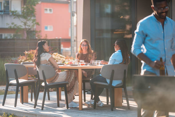 istock Beautiful Mixed Race Women Talking On A Barbecue Party 1416839507