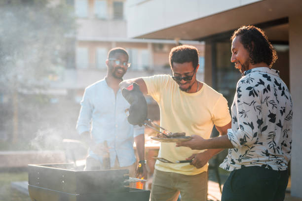 istock Young Mixed Race Men Doing A Grill On The Weekend 1416839515