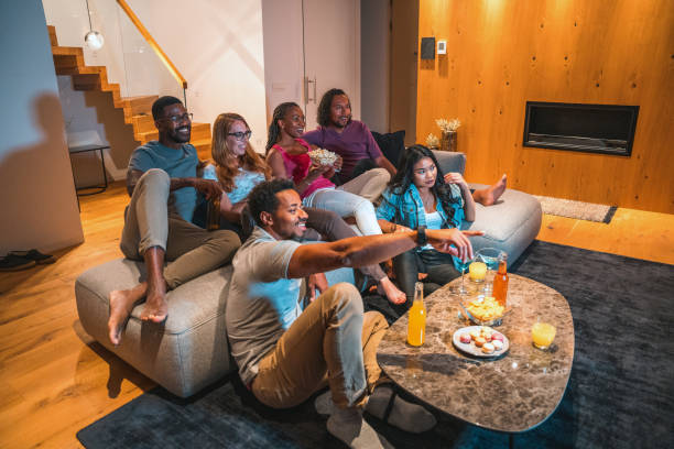 istock Multi-Ethnic Friends Watching Series And Having Fun Indoors 1416840473