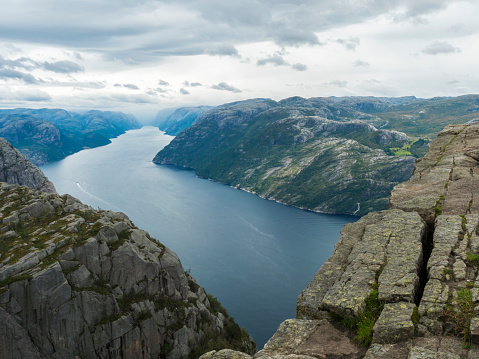 Preikestolen massive cliff at fjord Lysefjord, famous Norway viewpoint, no people.Moody autumn day. Nature and travel background, vacation and hiking holiday concept