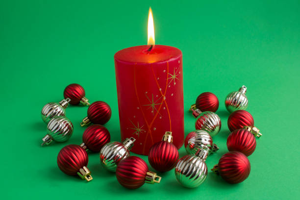 Candle and Christmas lights on the table.