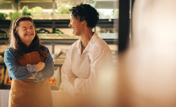 istock Grocery store workers laughing happily in their shop 1416869249
