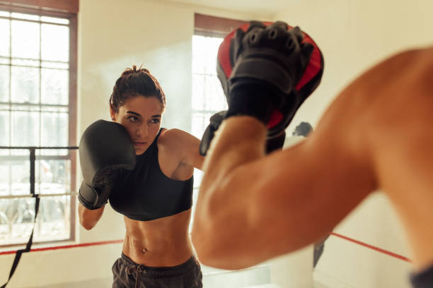 istock Muscular female pugilist throws a punch 1416873364
