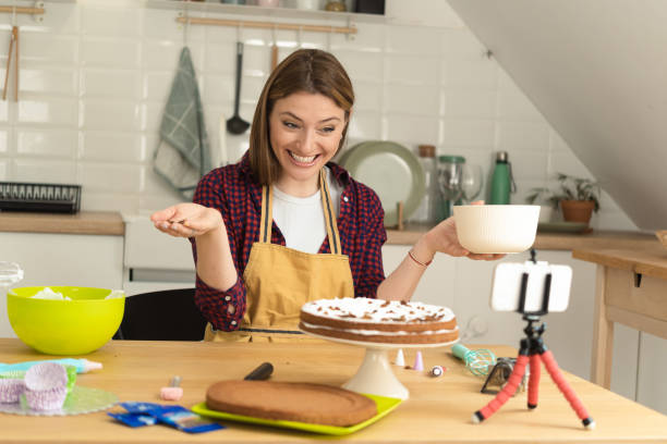 istock Portrait of a happy woman vlogging while making a cake 1416884077