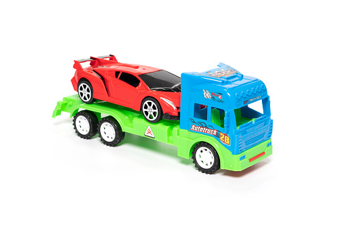 Car transporter truck toy isolated on white background. High quality photo