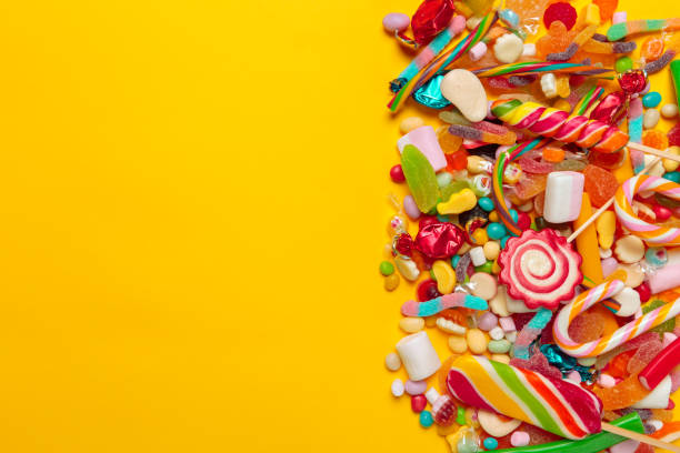 istock colored candies on yellow background 1416892824