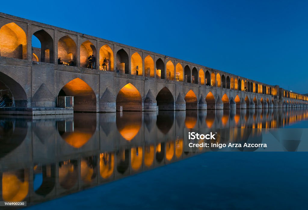 Si-o-se Pol bridge Si-o-se Pol (33 Bridge) reflected on Zayendeh river at night, Isfahan, Iran Isfahan Stock Photo