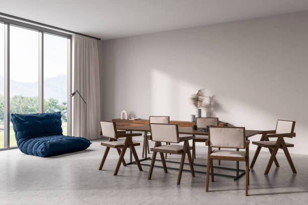istock Light chill room interior with wooden table and relax corner, panoramic window 1416904152