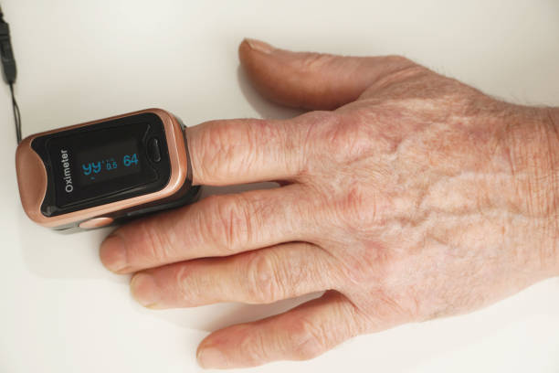 istock Senior man using pulse oximeter to measure  blood oxygen saturation. Checking health condition. Coronavirus pandemic. 1416906499