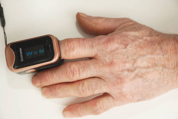 senior man using pulse oximeter to measure  blood oxygen saturation. checking health condition. coronavirus pandemic. - taking pulse oximeter medical oxygen equipment human lung imagens e fotografias de stock