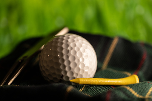 Golf ball on tartan kit bag