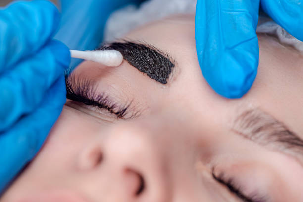 istock Tattoo Ideas. Beautician Tattooing Woman's Eyebrows Using Special Equipment During Process of Permanent Make-up. 1416909260