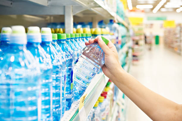 Drinking water plastic bootle in hand at store