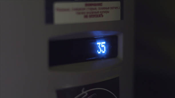 Close up of a screen on a vending machine with neon glowing number. Art. A number of a chosen cell of the vending maching, Close up of a screen on a vending machine with neon glowing number. A number of a chosen cell of the vending maching, replay photos stock pictures, royalty-free photos & images