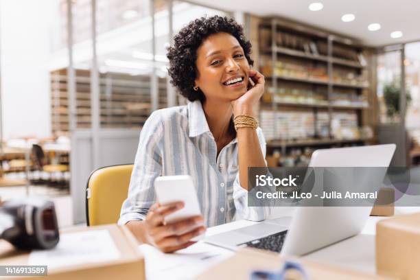 Successful Online Store Owner Smiling At The Camera In A Warehouse Stock Photo - Download Image Now
