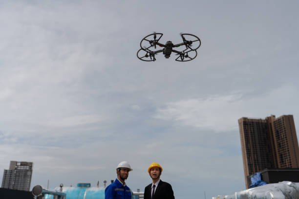 istock manager visit engineer working on the rooftop near pipe rack to inspection the progress by drone fly 1416913649