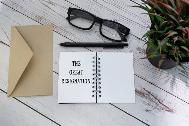 istock THE GREAT RESIGNATION text on notepad with brown envelop on wooden table. 1416913771