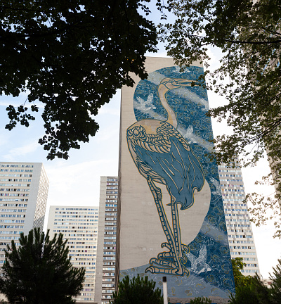 Paris, France - 14, July: View of the giant murales titled Héron bleuté painted by the artist STEW in the Place de Vénétie on July 14, 2022