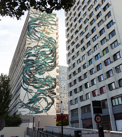 Paris, France - 14, July: View of the giant murales painted by the artist Pantonio on the Siena tower in the Place de Vénétie on July 14, 2022