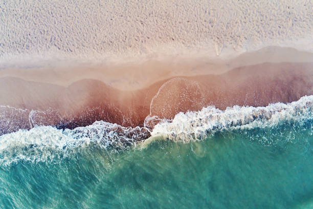 istock Coastline with blue sea waves and sand beach, top view 1416923423