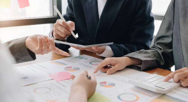 istock Teamwork with business people analysis cost graph on desk at meeting room. 1416924188