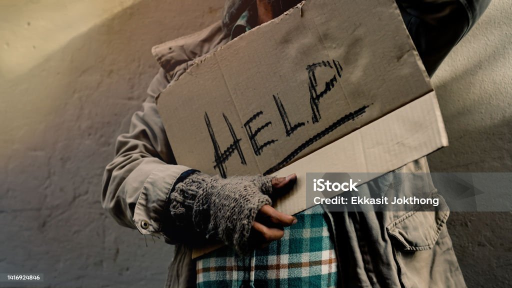 Close Up A sign for help in the hands of a dirty, dressed old man who is homeless, with food and work to do with no money to buy and sleeps on the streets every night. Homeless do not have home Begging - Social Issue Stock Photo