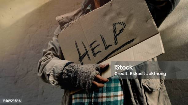 Close Up A Sign For Help In The Hands Of A Dirty Dressed Old Man Who Is Homeless With Food And Work To Do With No Money To Buy And Sleeps On The Streets Every Night Homeless Do Not Have Home Stock Photo - Download Image Now
