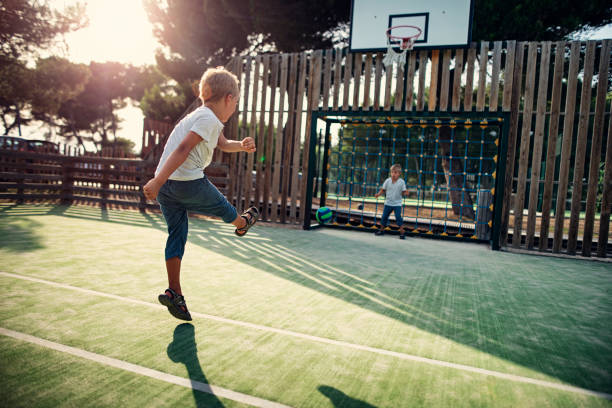istock Two little boys playing soccer in the schoolyard 1416926688