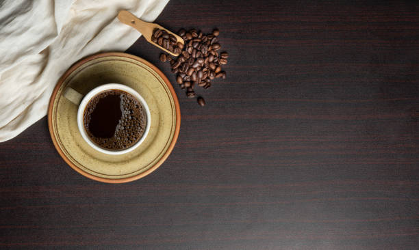 istock Cup of fresh brewed coffee with beans isolated on dark banner template 1416927116
