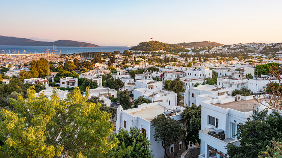 Bodrum city background. Aegean sea, traditional white houses, flowers, marina, sailing boats, yachts in Bodrum town Turkey. Aerial View