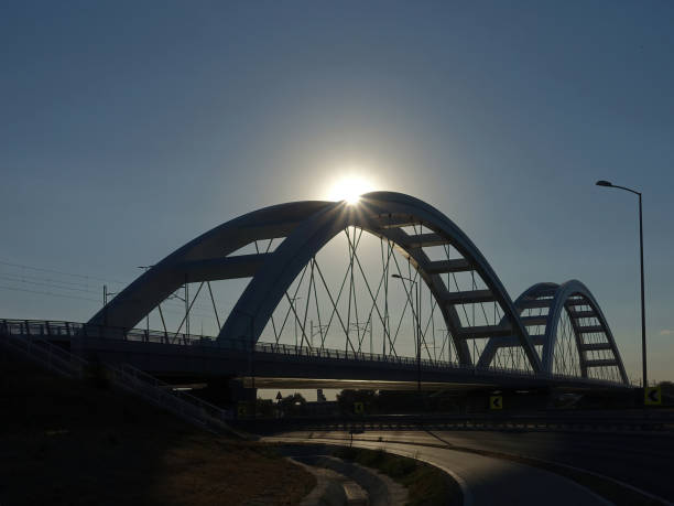istock Silhouette of bridge with sun beams over it 1416933681