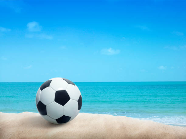 istock Soccer ball on sandy beach after game 1416937284