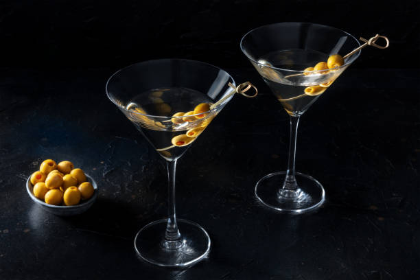 istock Martini, two glasses with spicy olives on toothpicks, on a black background 1416939119