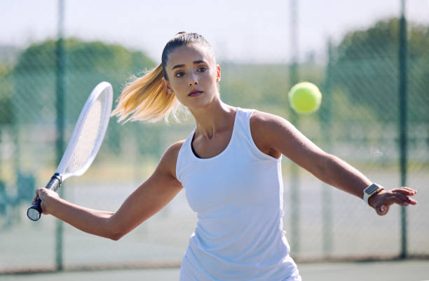 istock playing a serious competitive match at a sports court. Female athlete practicing her aim during a game. Woman enjoying a outdoor hobby she is passionate about. 1416939452