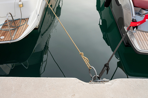 yachts and motor boat in marina port, front view