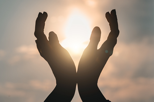 Hands reaching out to sky.