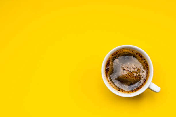 istock Frothy coffee in a porcelain cup on yellow background 1416941911
