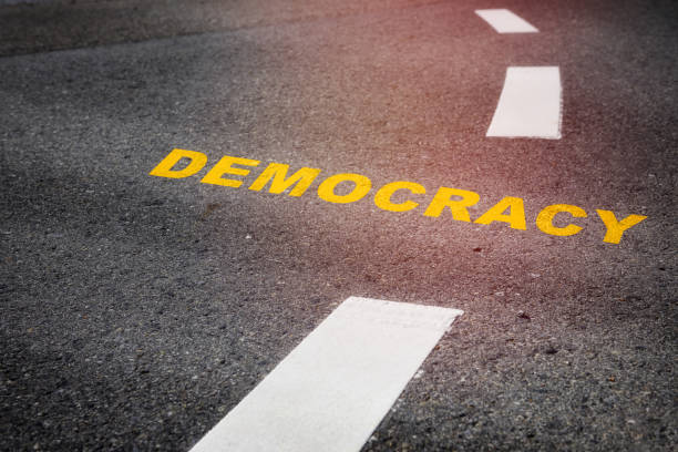istock Democracy written on asphalt road 1416942649