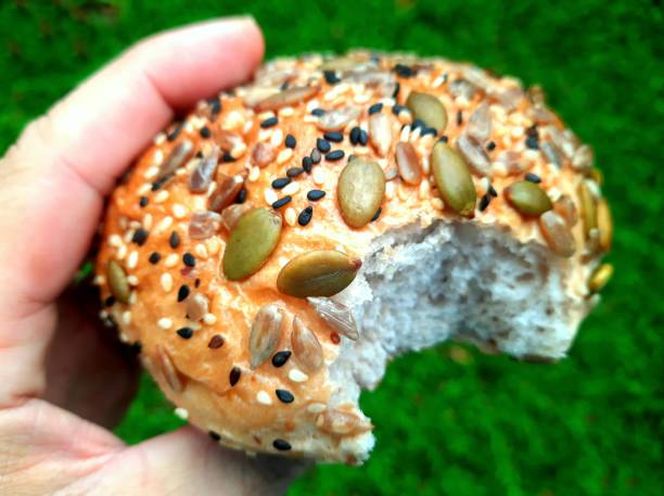 Biting Bread Bun with Sunflower and sesame seeds.