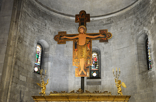 Antique cemetery statue close up: Jesus on cross.
